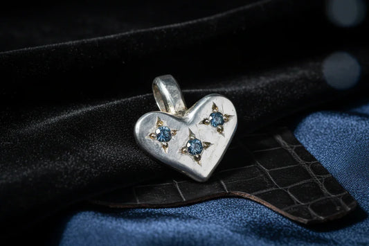 Silver heart pendant with blue gemstones, handcrafted fine jewelry on black velvet