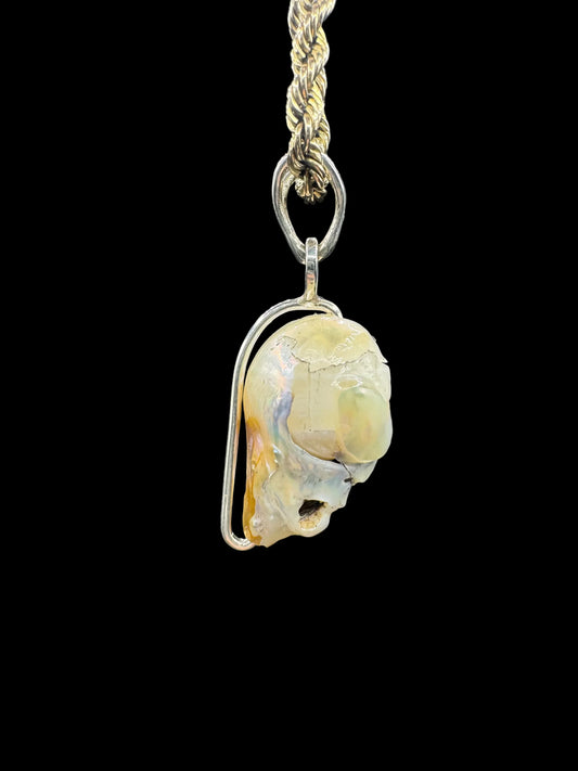 Handcrafted opal and silver pendant on braided chain, artisan jewelry on black background