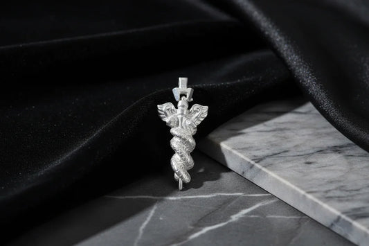 Sterling silver caduceus pendant on marble with black velvet, handcrafted jewelry photo
