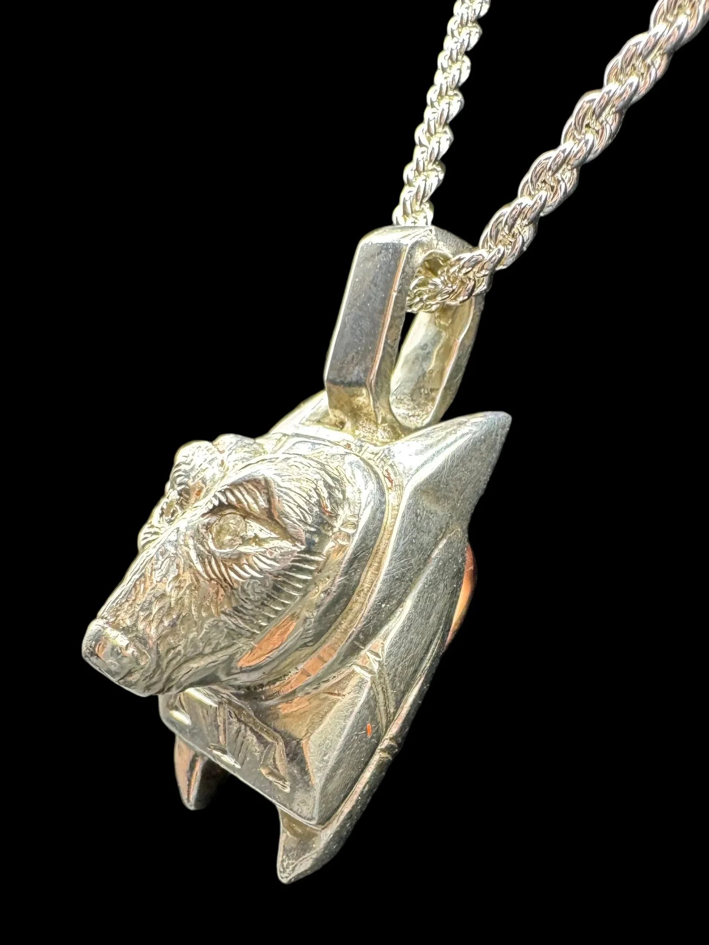 Handcrafted silver bear head pendant on rope chain, fine art jewelry on black background