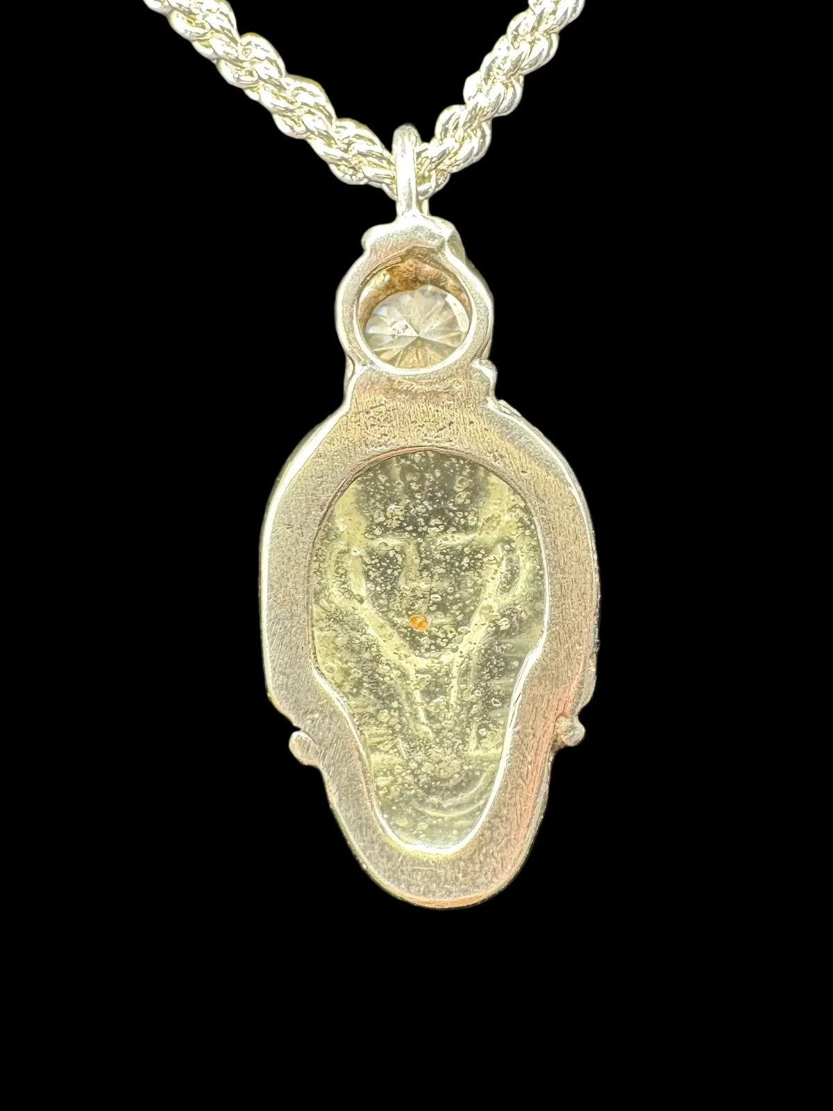 Handcrafted silver pendant necklace with unique textured center and clear gemstone accent
