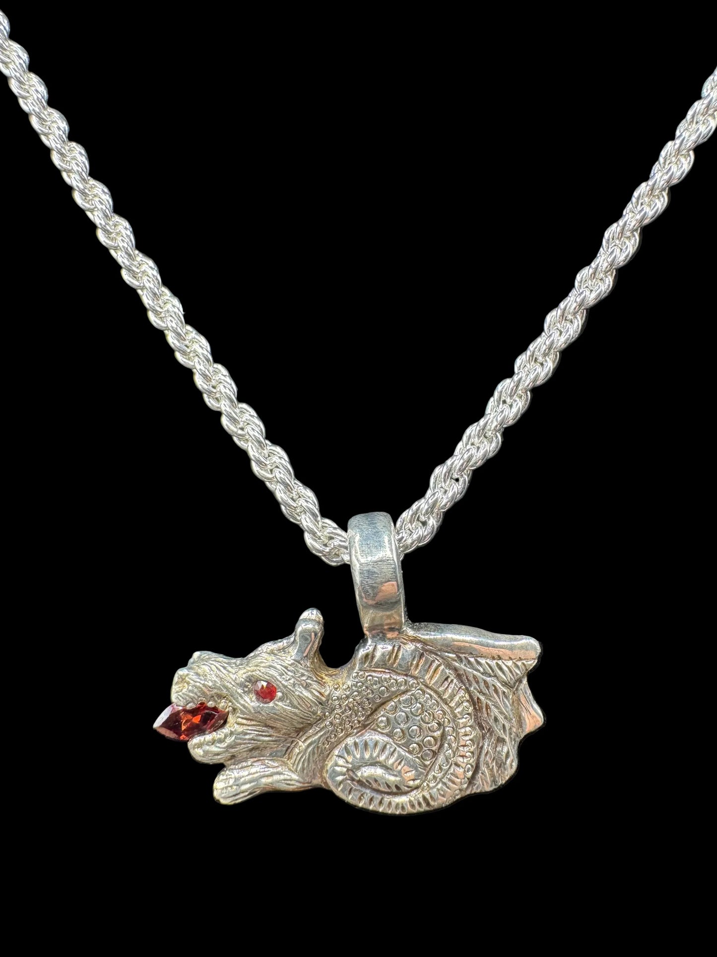 Handcrafted silver animal pendant with red gemstone eyes on a rope chain necklace