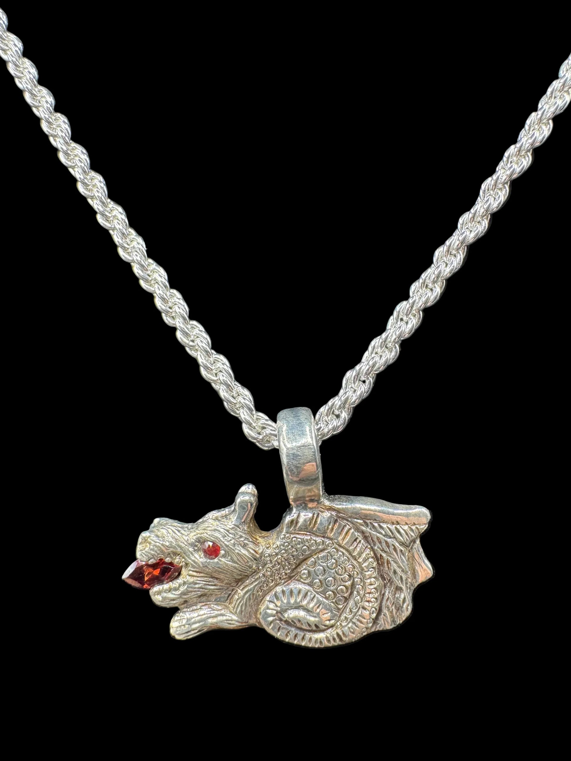 Handcrafted silver animal pendant with red gemstone eyes on a rope chain necklace