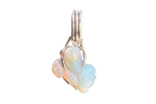 Handcrafted silver and opal pendant with iridescent colors on a neutral background