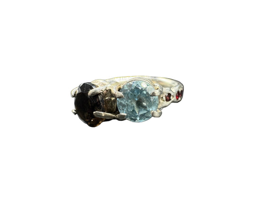 Ring with a blue gemstone on a textured surface