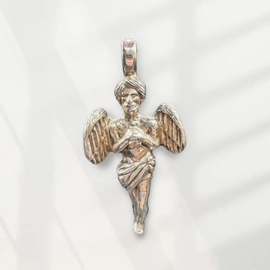 Handcrafted silver angel pendant with detailed wings and robe on a light background