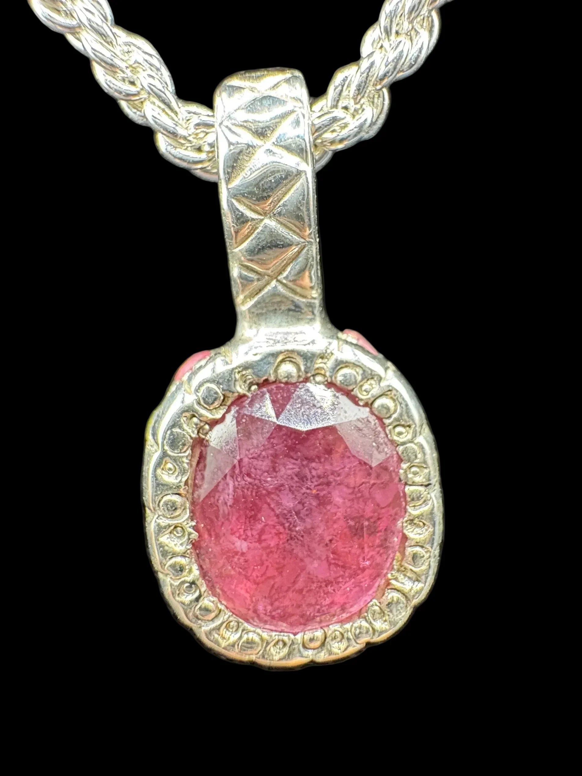 Handcrafted silver necklace with large oval pink gemstone pendant, textured bezel setting