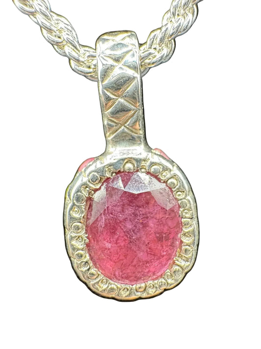 Handcrafted silver necklace with large oval pink gemstone pendant, textured bezel setting