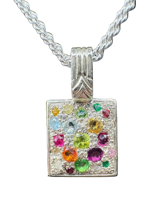 Square silver pendant with multicolored gemstones on a twisted chain necklace