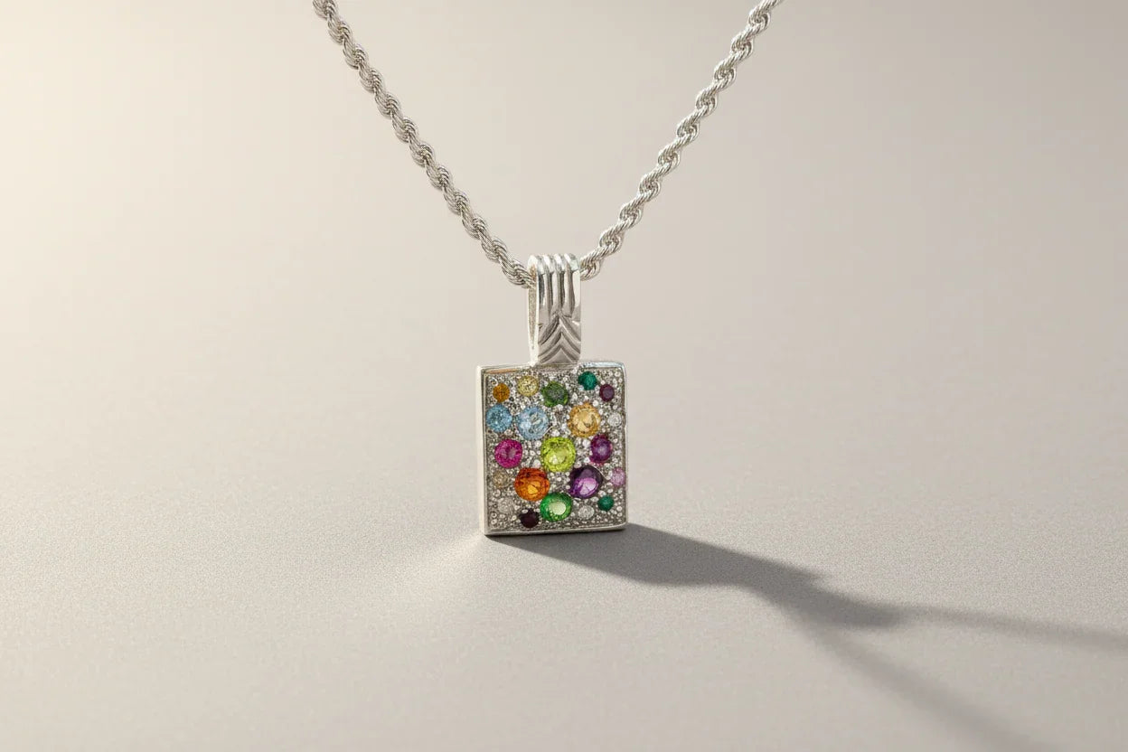 Silver rope chain necklace with a rectangular pendant featuring colorful gemstones