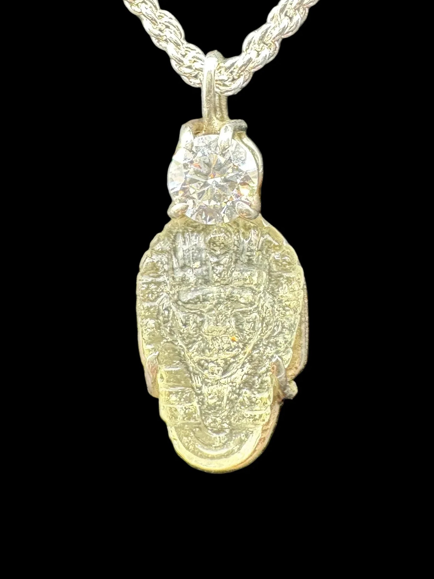 Gold scarab beetle pendant necklace with diamond accent, handcrafted jewelry on black background
