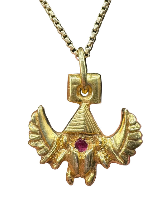 Handcrafted gold pendant with ruby gemstone and winged design on a chain necklace