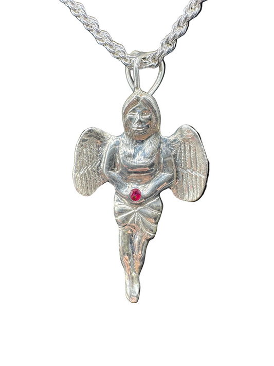 Silver angel pendant with a red gemstone on a black background