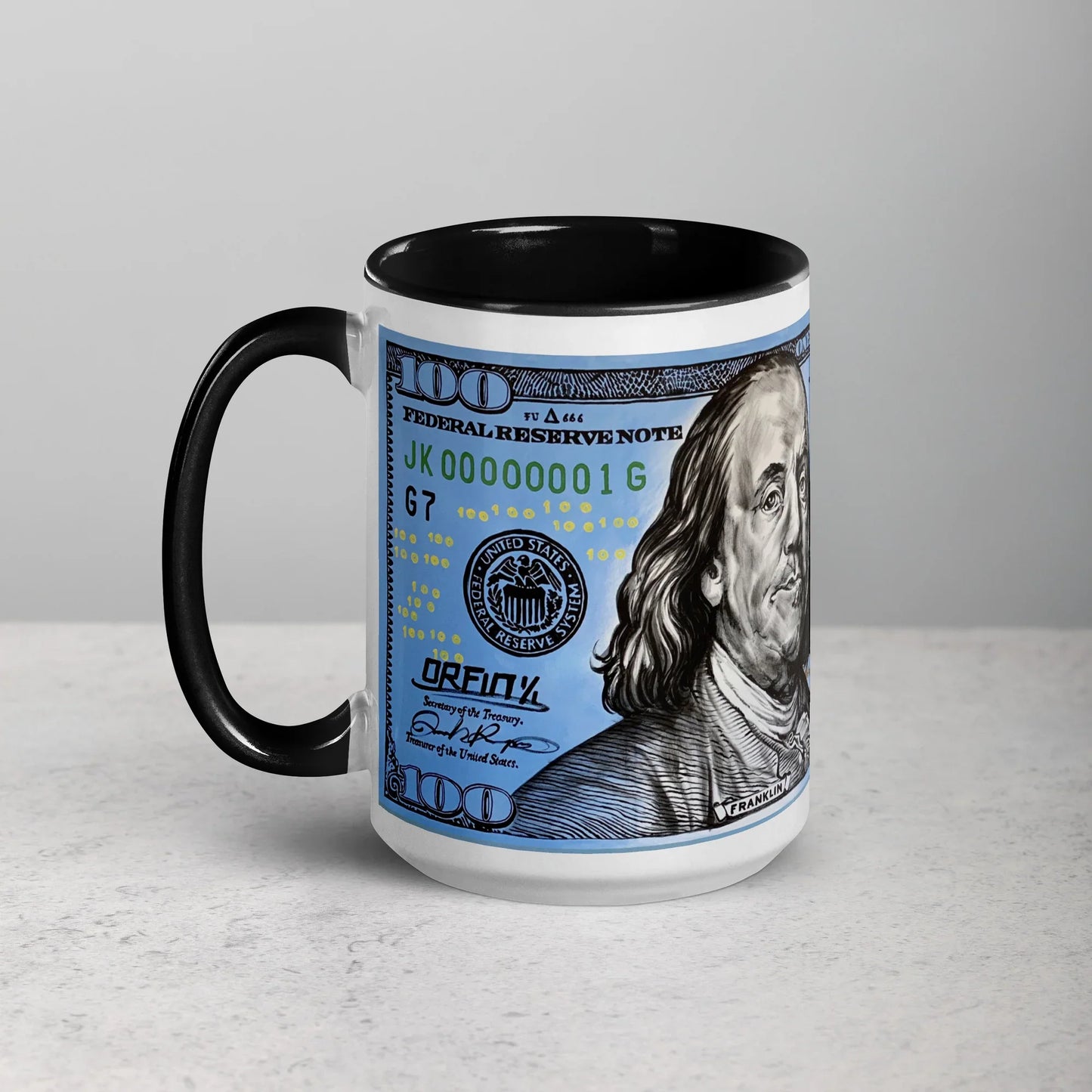 White ceramic mug with black interior and handle, featuring a $100 bill design print.