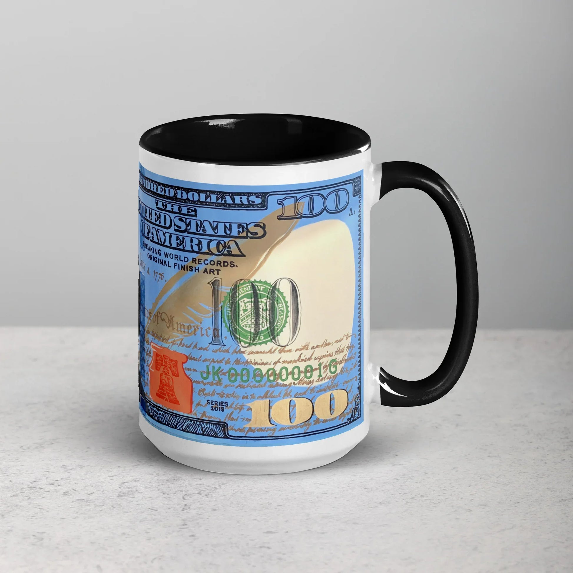 White ceramic mug with black handle and interior, featuring a $100 bill design on the side